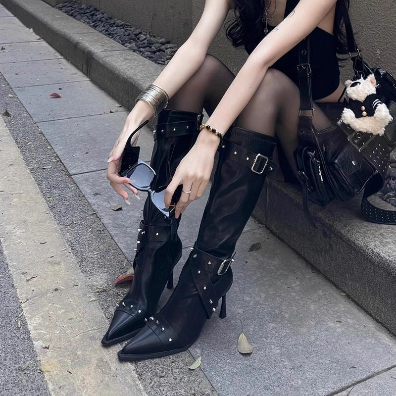 Pointed-toe high-heeled leather boots.